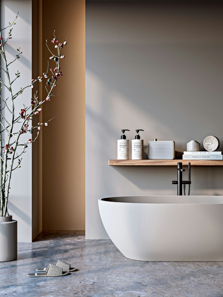 Minimalist neutral bathroom with natural light and a freestanding bathtub